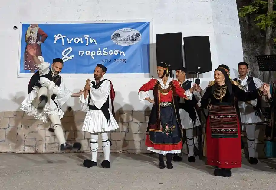 a group of people in traditional clothing dancing